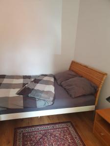 a bed with two pillows on it in a room at Biedronka- samodzielny apartament dla 3 osób z miejscem parkingowym in Sopot