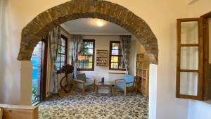 an archway in a room with chairs and windows at Old town Cozy Villa in the heart of Antalya in Antalya