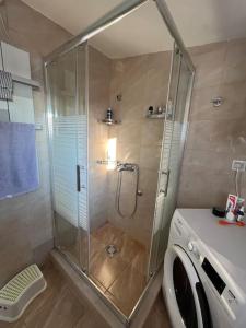 a shower in a bathroom with a washing machine at Apartment Gloria 4 NEW in Belgrade