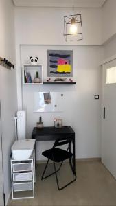 a black desk in a room with a sink at Como la flor, Gizi Attikis in Athens