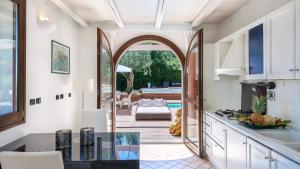 a kitchen with an archway leading to a patio at VILLA ROSSA 12, Emma Villas in Misano Adriatico