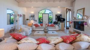 a living room filled with lots of pillows at VILLA ROSSA 12, Emma Villas in Misano Adriatico