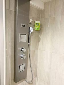 a shower with a shower head in a bathroom at « Le Vieux Lyon » 45 m2 tt équipé Clim in Lyon +16 photos