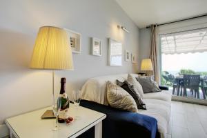 a living room with a couch and a table with a lamp at Your Vacation Retreat Right On The Beach in Casares