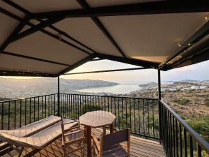 a balcony with a table and chairs and a view at Mandra - Nature Living in Bodrum City