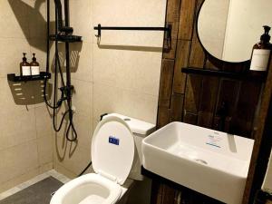 a bathroom with a white toilet and a sink at 4 Bedroom Villa near Clark (Casa Isabela) in Mabalacat