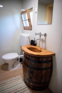 un baño con lavabo hecho de barril de madera en Glamping Paradise Škatlar, en Otočec