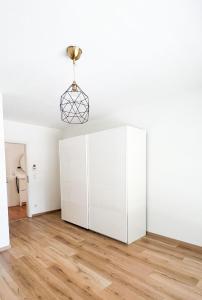 a room with a white cabinet and a lamp at 2 ZKB Apartment in Mannheim in Mannheim