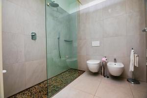 a bathroom with a shower and a toilet and a sink at Prime blue suite - Giardini in Riccione