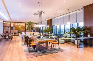 a living room with tables and chairs and a couch at Wellness Park Hotel Bactria in Samarkand