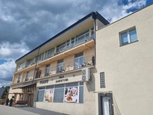 a building with a balcony on the side of it at Figaro Apartaments in Gdynia