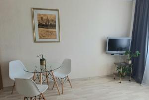 a dining room with a table and a tv at Better Place Varso Center in Warsaw