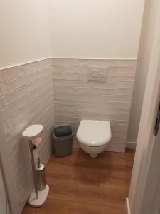a small bathroom with a toilet and a trash can at T2 hyper centre LONS LE SAUNIER in Lons-le-Saunier
