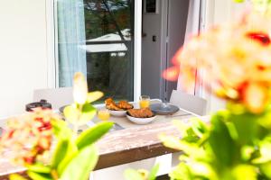 a table with bowls of food and drinks on it at Tropical Cocooning in Saint-François