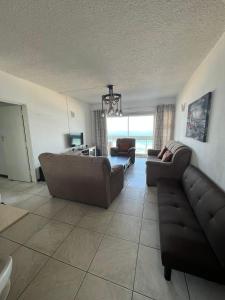 a living room with two couches and a couch at Stella Maris 104 Amanzimtoti in Amanzimtoti