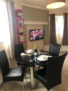 a dining room with a black table and black chairs at HALF PRICE OFFER - Exeter City Apartment in Exeter