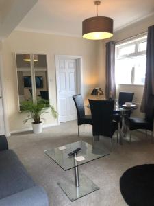 a living room with a couch and a table and chairs at HALF PRICE OFFER - Exeter City Apartment in Exeter