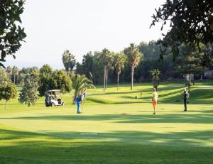 a group of people playing golf on a golf course at Casa Horadada in Algorfa