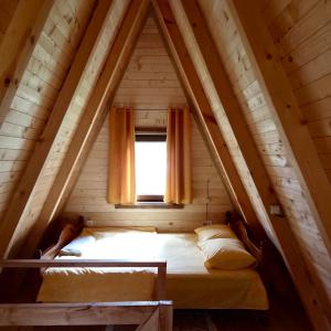 Łóżko w małym pokoju z oknem w obiekcie Family S house - Komarnica w mieście Šavnik