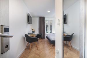 a bedroom with a bed and a table and chairs at Residence INN Rijeka in Rijeka