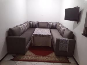 a brown leather couch with a coffee table in a room at Appartement in Agadir