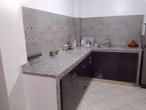 a kitchen with a sink and a counter top at Appartement in Agadir