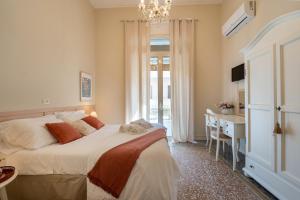 Postel nebo postele na pokoji v ubytování Joy's Bnb Ortigia