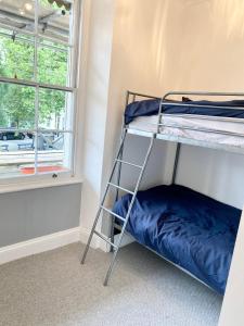 a bunk bed in a room with a window at 2 bed flat, 1 bed flat Torquay, Torbay, Devon in Torquay