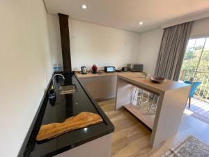 uma cozinha com pia e bancada em Casa dos Neves Suíte Master em Campos de Jordão