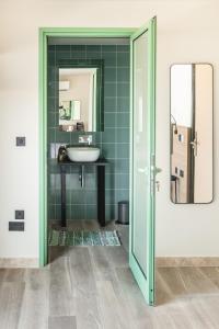 a bathroom with a sink and a mirror at Privilege Suit SLiema in Sliema