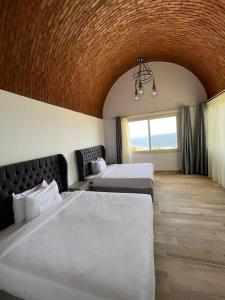 a hotel room with two beds and a window at Azzurra two-bedrooms apartment at Sahl Hasheesh in Hurghada