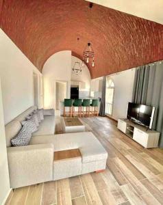 a living room with a white couch and a television at Azzurra two-bedrooms apartment at Sahl Hasheesh in Hurghada