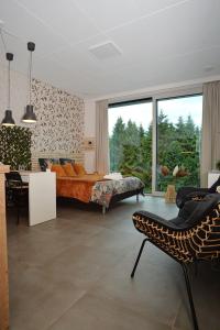 a bedroom with a large bed and a large window at Au Vieux Chêne in Malmedy