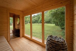 a room with a large window in a log cabin at Manoir de Laroque Delprat in Autoire