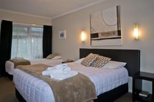a hotel room with two beds with towels on them at Picton Accommodation Gateway Motel in Picton