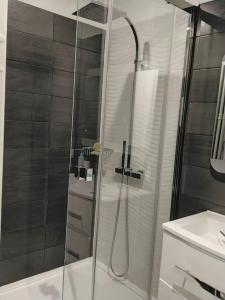 a shower with a glass door in a bathroom at Cigalou 2km Marina Olympique - Parking gratuit in Marseille