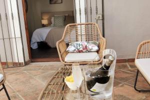 a room with a chair and a bottle of wine at Villa Valdiego in La Herradura