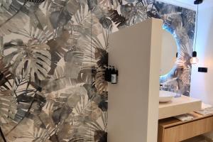 a bathroom with a wall mural of palm trees at Villa Valdiego in La Herradura +22 photos