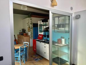 a kitchen with a counter and a table in it at Jazz House in Solanas