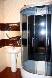 a bathroom with a shower and a sink at Christy Hotel in Goris