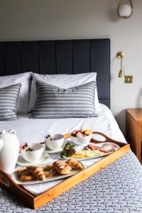 a tray of food on top of a bed at Stirrups Hotel in Bracknell