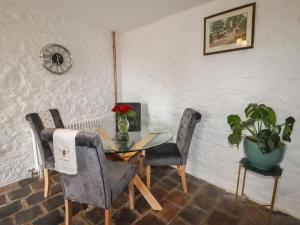 a dining room with a glass table and two chairs at The Old Hall in Holywell