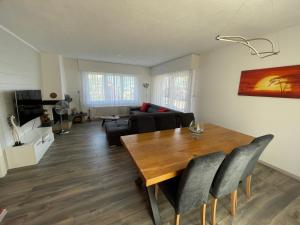 a living room with a table and a couch at Les Dents-du-Midi in Monthey