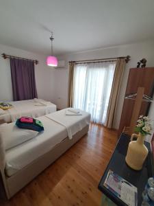 Zimmer mit 2 Betten und einem Tisch mit Vase in der Unterkunft Smyrna Pansiyon in Kaş