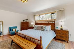 a bedroom with a bed and a chair and a window at Walling Mountain Retreat in Groveland