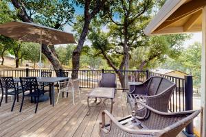 a deck with chairs and tables and an umbrella at Walling Mountain Retreat in Groveland