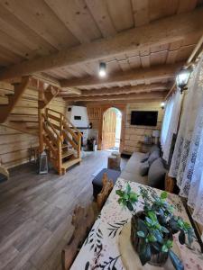 a living room with a couch and a table in a cabin at Domek Góralki in Zakopane