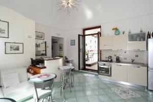 een keuken en een woonkamer met een tafel en stoelen bij MeFra Camere - Amalfi Coast in Atrani