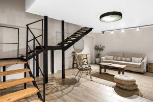 a living room with a loft bed and a couch at Hotel Anilevich Mansion in Beer Sheva