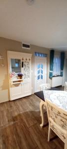a dining room with a table and chairs in a room at Borostyánkút Wellness Home Bakonybél in Bakonybél